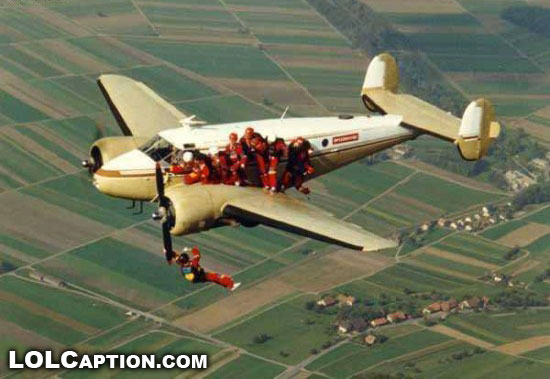 wtf-funny-photos-lolcaption-people-hanging-off-plane-propeller-skydiving